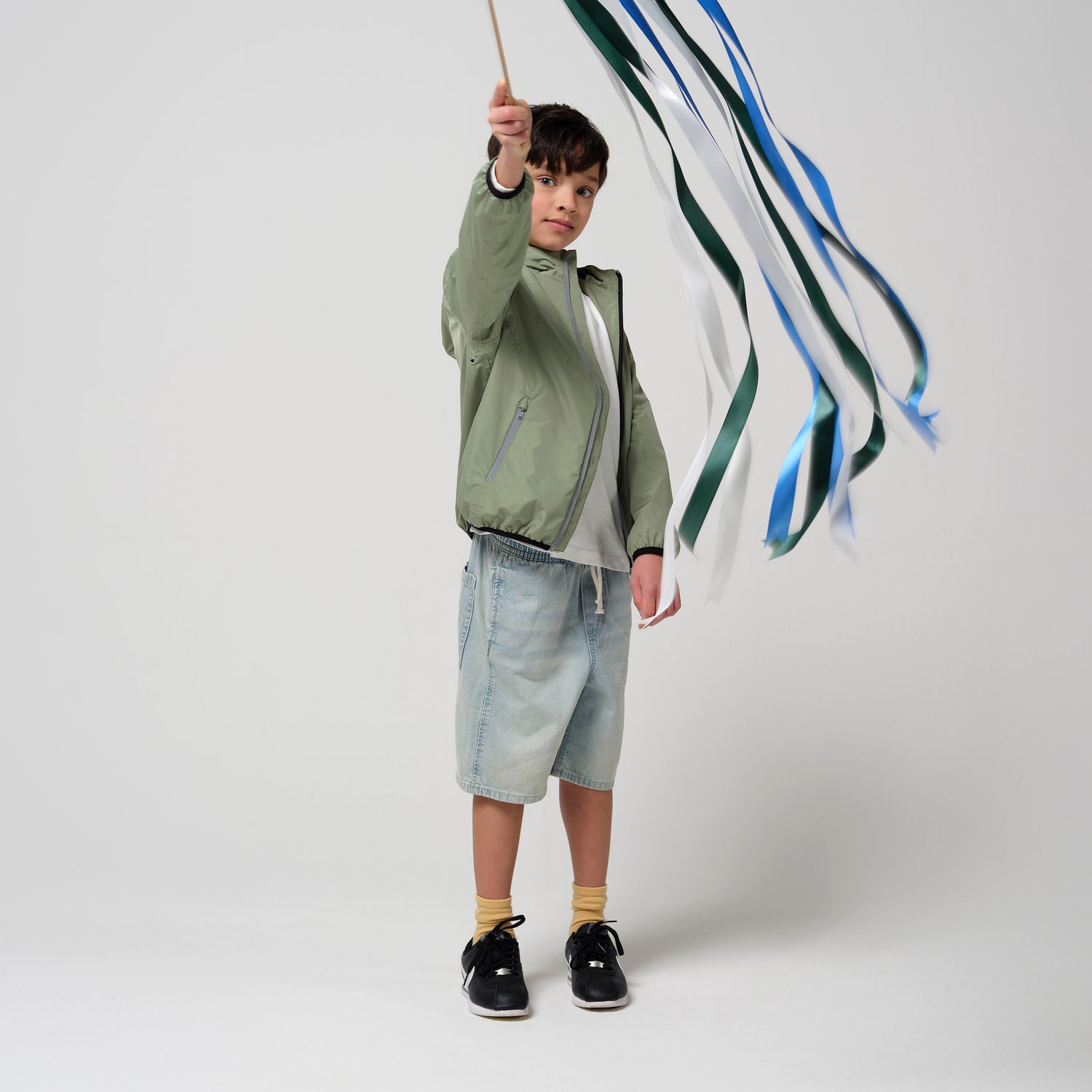 Kid wearing GOSOAKY HAPPY HORSE Stowable Waterproof Jacket color oil green - from Outerwear collection of Spring / Summer 2026